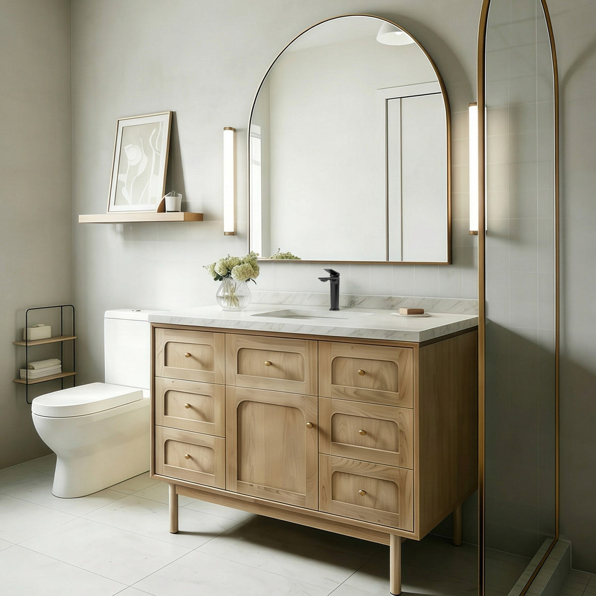 Modern bathroom vanity with a single-hole black faucet and arched mirror